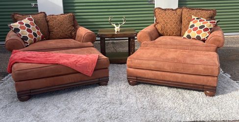 Two orange suede over sized lounges with ottamans
