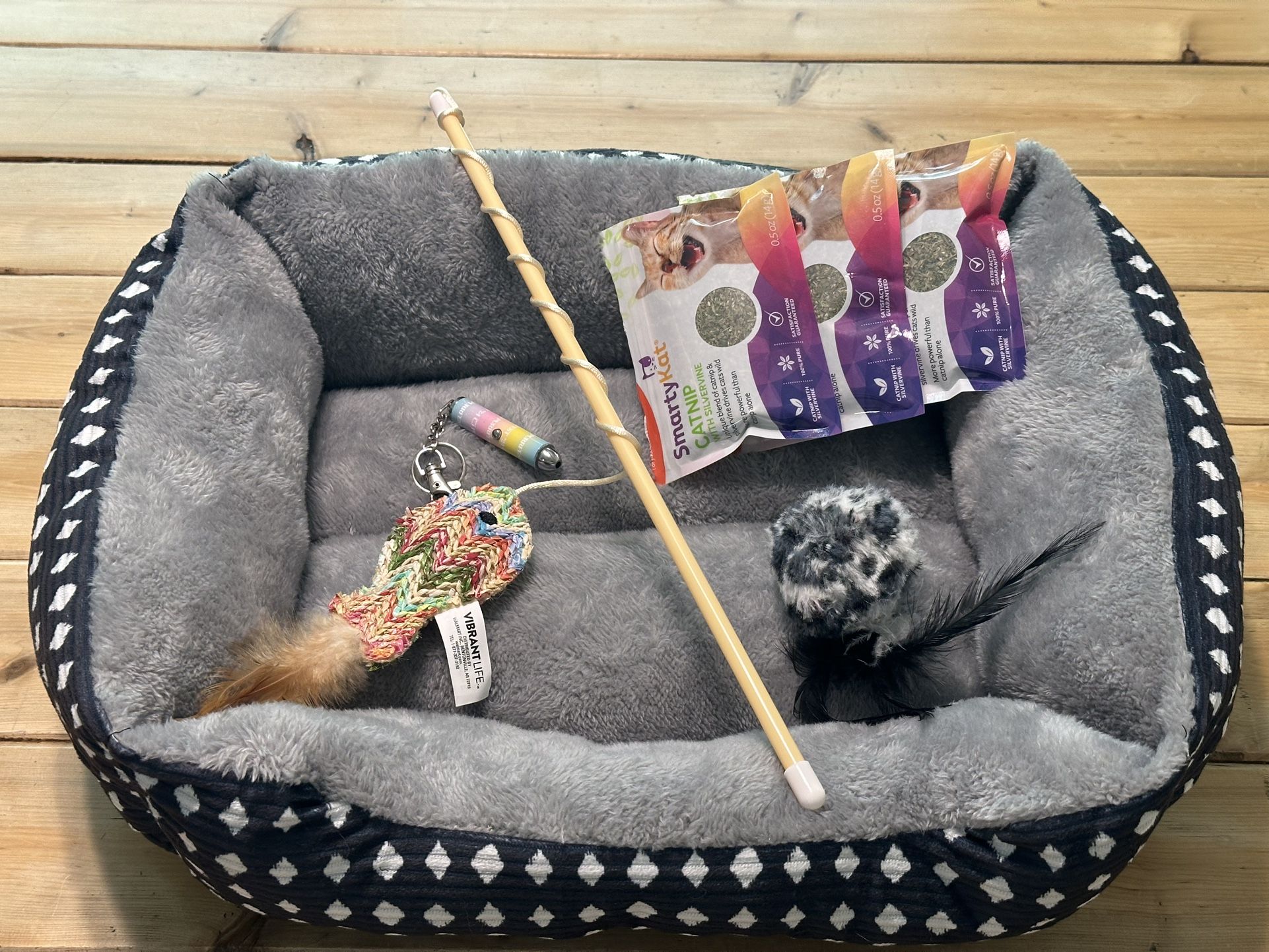 * 1x Brand New Bed * 2x CAT Toys - Bird and a Vibrant Fish on Pole is Brand New  * 3x Cat Nip - Full Packages  * And A Red Light Toy - Very Bright