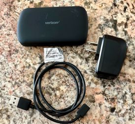 Verizon Orbic Speed (RC400L) 4G LTE mobile Wi-Fi hotspot with its USB charging cable and wall adapter