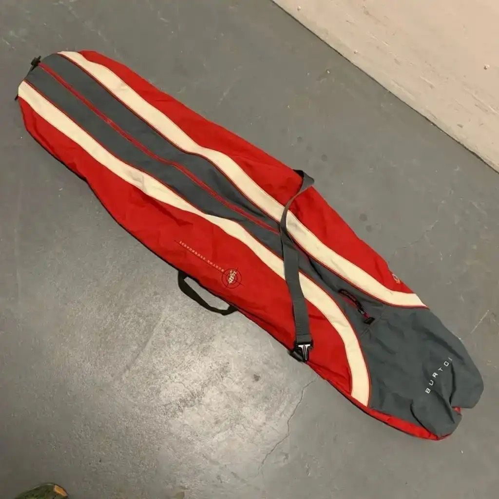BURTON SNOWBOARDS Travel Carry Bag for Snowboard. Color way is Red Gray Cream  Great pre-owned condition. There is a mark on the bottom of the bag (sh