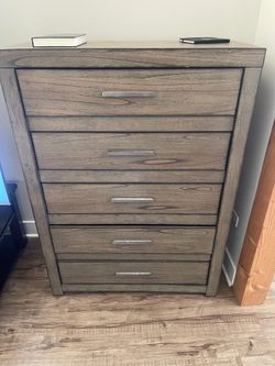 Wooden 5 drawer dresser with metal handles from Darvin