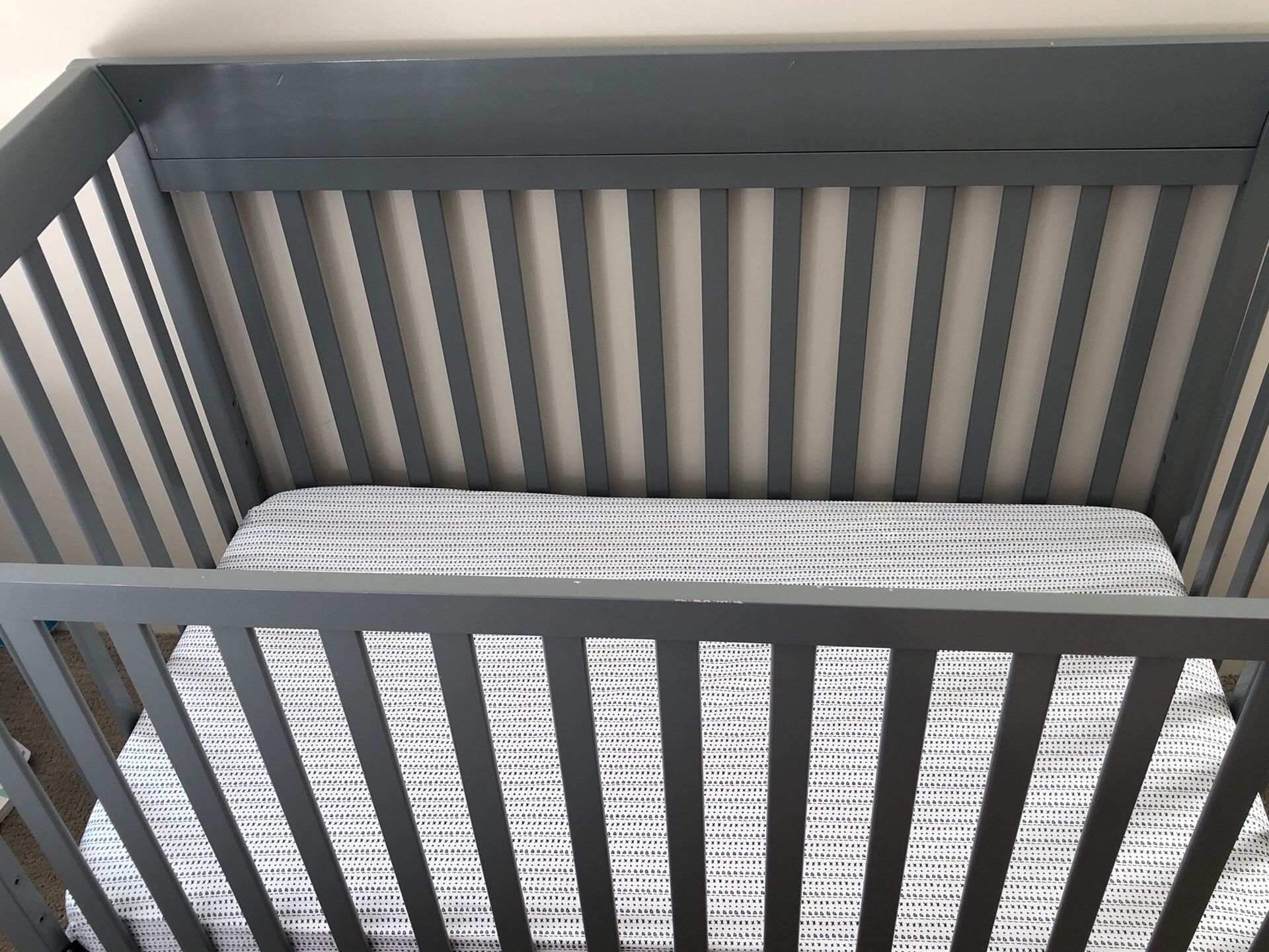 Grey crib and mattress