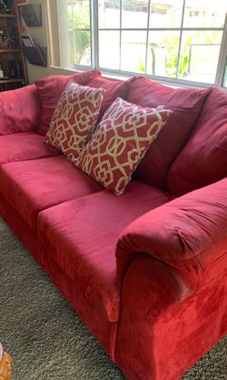 Large red micro Suede couch very comfortable. Needs to be cleaned