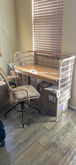 rattan/wicker desk with a matching cushioned swivel chair
