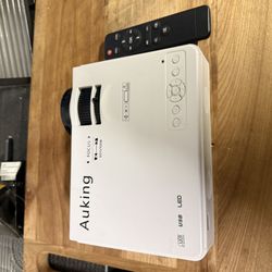 AuKing Mini Projector With A 120 Inch Screen 