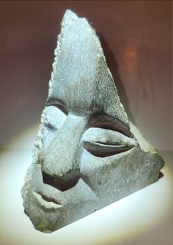 Carved stone face rock