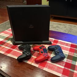 PS4 Pro with 1TB SSD three controllers vertical stand.