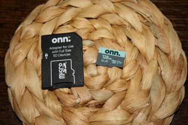 This onn. branded 128GB microSDXC flash memory card includes a full-size SD adapter for broader device compatibility.