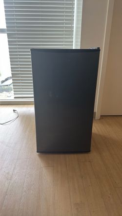 Midea 3.3 cubic foot compact refrigerator with a stainless steel finish