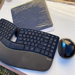 Microsoft keyboard, Bluetooth mouse, and mouse pad