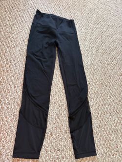 Black lululemon leggings with mesh seams and detailing