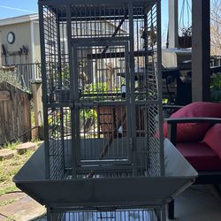 Large metal bird cage on wheels