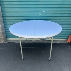 48" Round plastic tables. Accommodates 5-6 guests.