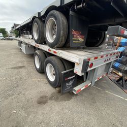 Two flatbed semi trailers