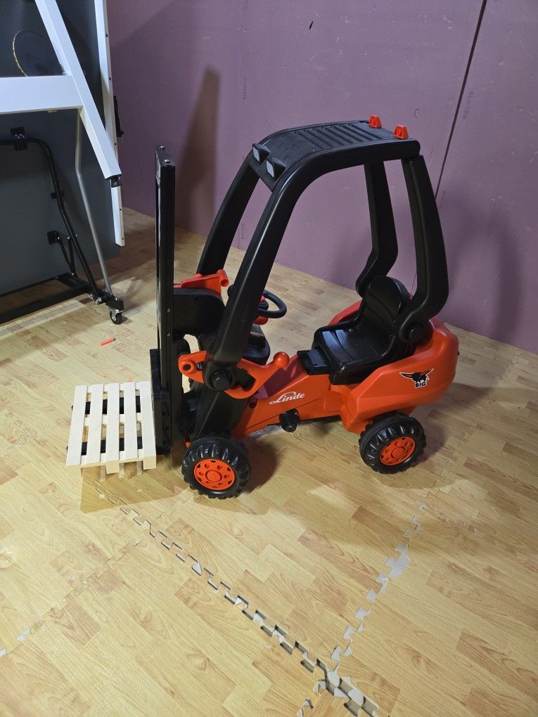 Kids riding forklift toy with pedals