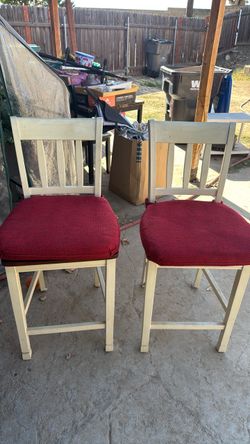 Two bar height chairs with cushions