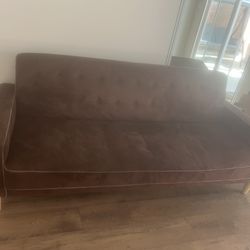 Brown sofa that opens into bed