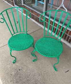 Two green patio chairs