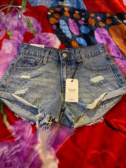 Forever 21 distressed high-rise denim shorts in a medium wash with a frayed hem Size 24