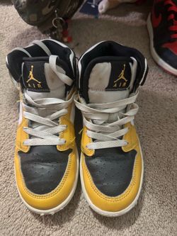 Black and yellow Jordan 1 mids