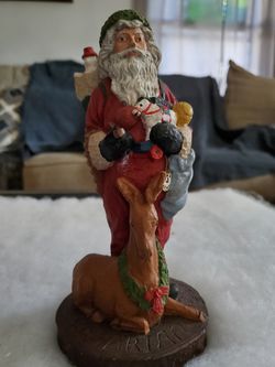 Ceramic Santa with a dear at his feet and a bag if toys!