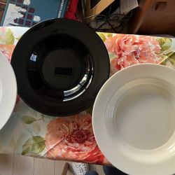 Three large white serving bowls, and one black! Super Cool. 