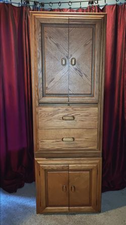 Tall-standing oak wood closet/cabinet.