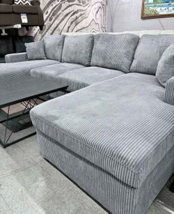 Brand new grey corduroy Sectional Sofa with double chaise and two accent pillows.