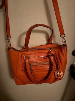 This is a Michael Kors Gilmore Satchel in a vibrant orange leather with gold hardware.