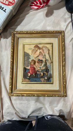 This vintage framed 3D relief sculpture depicts a guardian angel
