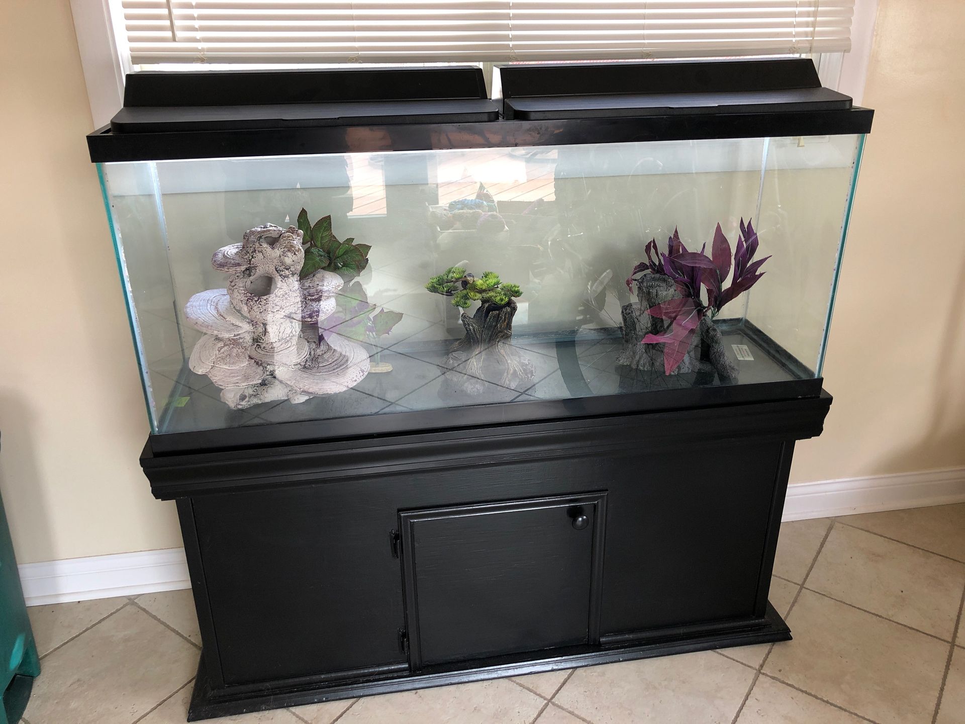 55 gallon fish tank with hood lights, tank stand, tank decor and gravel..