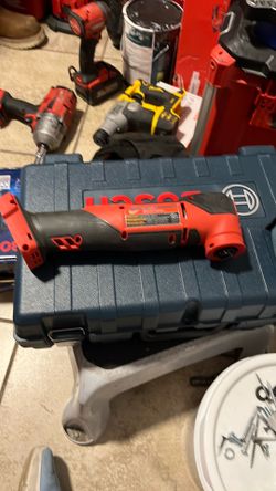 Milwaukee M12 cordless oscillating multi-tool, designed for cutting and sanding in tight spaces.