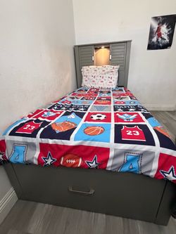 Gray twin-size bed from Bob’s Furniture