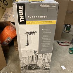 Thule Expressway 4 Bike Rack New In Box.  4 bikes, locks to receiver included, bike arm folds down when not in use, integrated locking cable 
