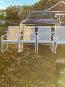 Four Heavy Duty Stackable Chairs.