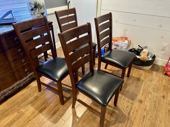 Four brown lightly used dining room chairs