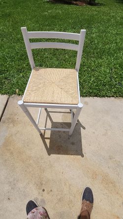 ladderback bar or counter stool featuring a natural hand-woven rush seat.
