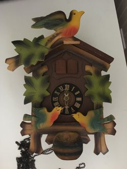 Vintage made in Germany cuckoo clock with birds and people inside the cuckoo