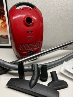 Red Miele titan vacuum cleaner and accessories extra bags