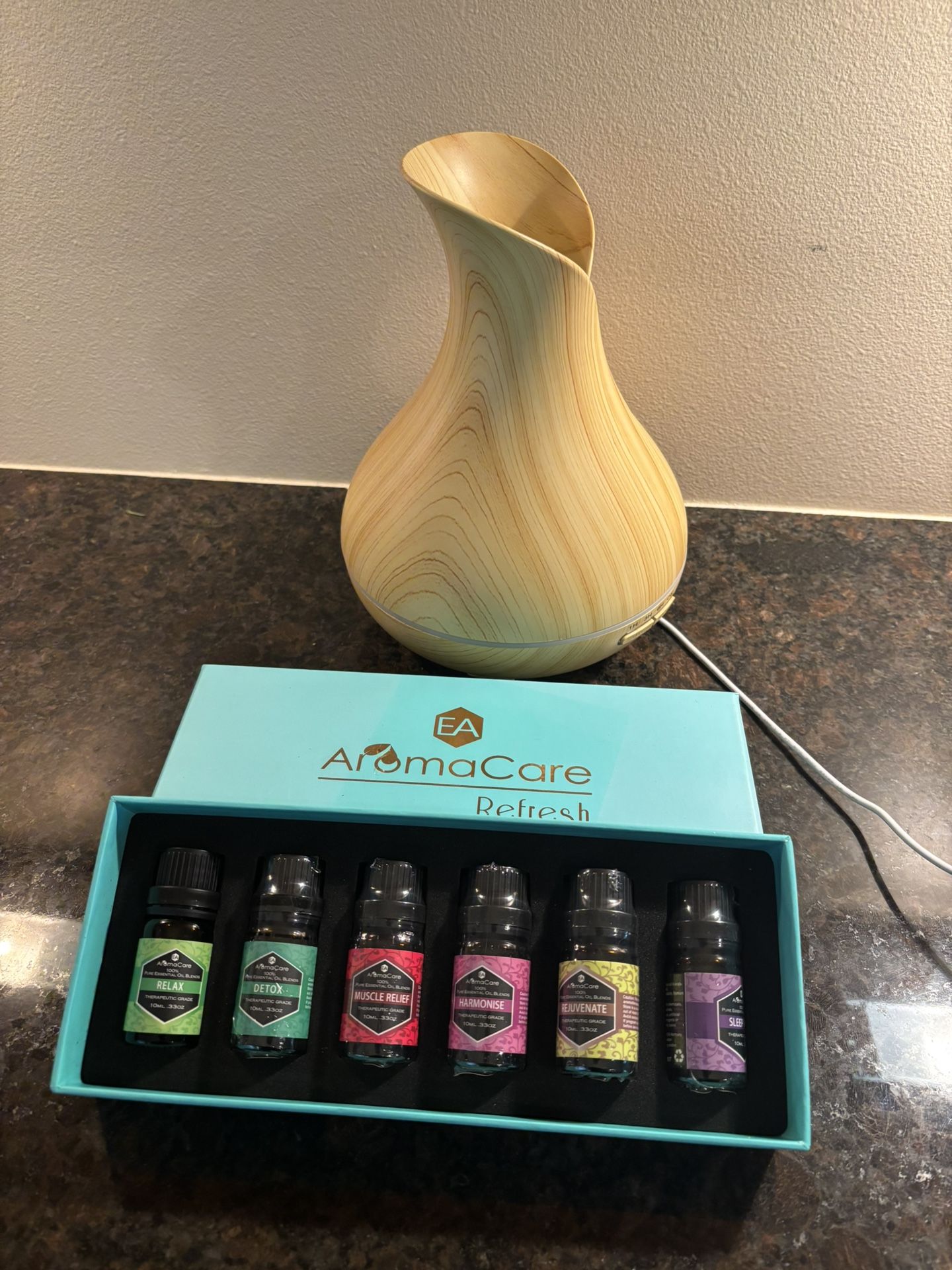 aromatherapy diffuser and a set of essential oils from "AromaCare Refresh"