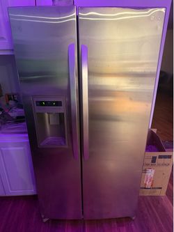 LG stainless side-by-side refrigerator with an in-door ice/water dispenser