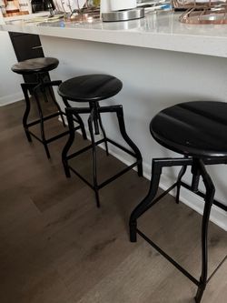 Set a three black adjustable height, metal frame, wood seat barstools