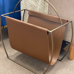 Hardage magazine rack by Mercury Row. Overall: 23” H x 22” W x 10” D. Faux leather. MSRP: $300. Our price: $95 + Sales tax