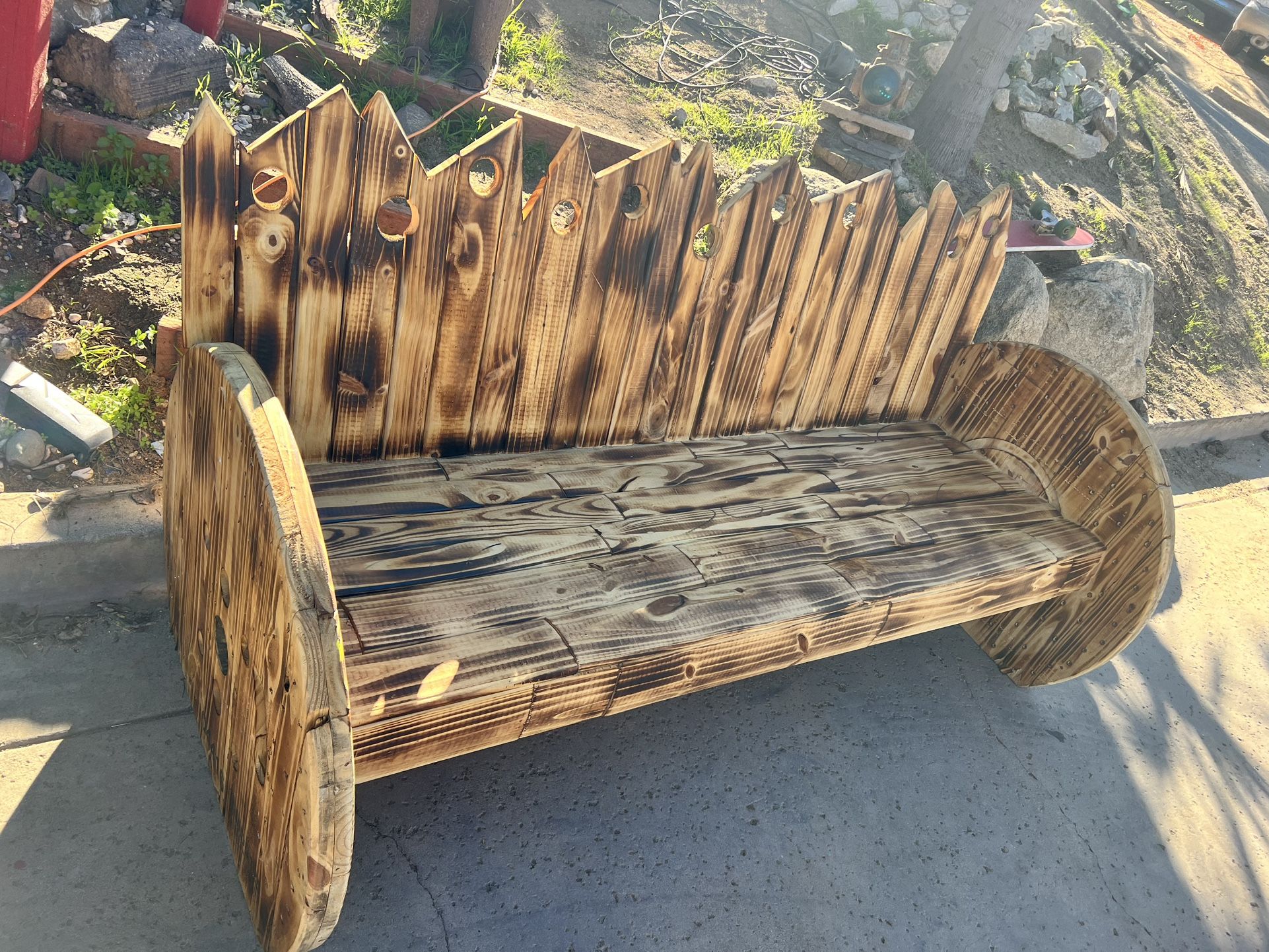 Rustic wire-spool bench, burn-finished reclaimed wooden
