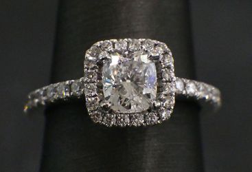 18k White Gold Engagement Ring Containing a 1.01ct Cushion Cut Diamond graded D Color with SI2 Clarity, surrounded by .54ct in diamonds