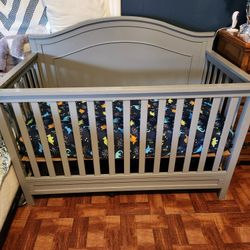 baby crib and new mattress and a baby carrier  