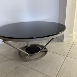 Unique Coffee Table 36” In Diameter With Metal  Frame And Black Glass Top! 