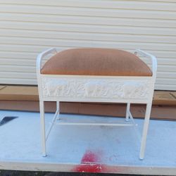 White metal stool with cushion.