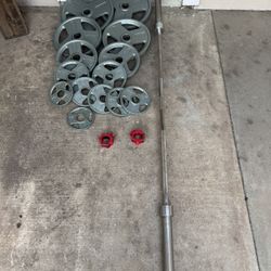 Olympic weights 255lbs total plus 7ft 45lbs bar with clamps