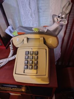 Bugs Bunny- Sitting on top of a vintage Key pad phone.